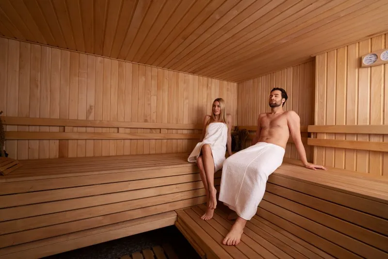 Couple relaxing in a traditional wooden sauna